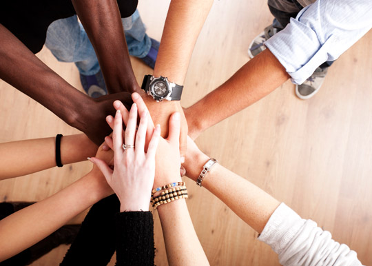 Diverse group with hands together