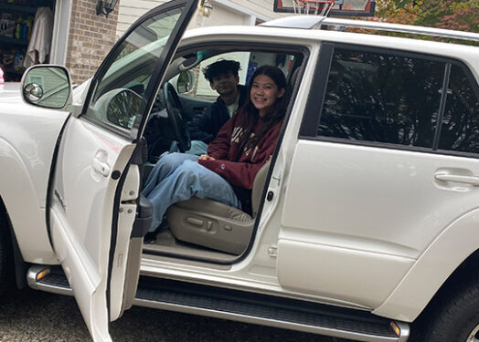 young girl and passenger sitting in suv